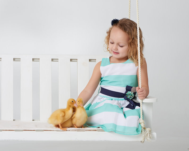 girl on porch swing with ducklings spring photos