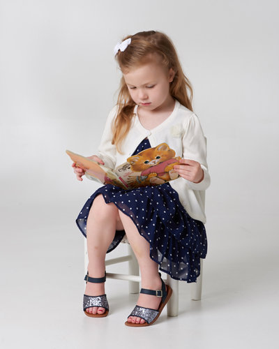 little girl reading story book photo